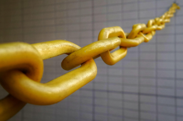 Yellow chain against tiled background